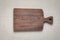 Handmade walnut wood chopping board with traces of use on burlap