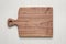 Handmade walnut wood cutting board on sackcloth background.