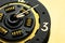 Handmade watches on a gold background. A clock from a car clutch disc. Black watch with gold elements. Trending color