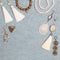 Handmade white and bronze jewelry on the gray woolen background