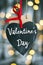 Handmade wooden heart shape with elegant text on Valentine`s Day, romantic vintage design with bokeh lights background. Concept of