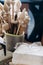 Handmade wooden spindles stand in a glass in a workshop