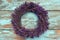 A handmade wreath of lavender on an old blue wall.