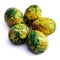 Handmade yellow green easter eggs painted marbled over white background