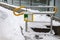 Handrail with button to help disabled people. Around lies snow