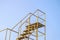 The handrail yellow steel stair with blue sky background