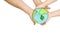 Hands of an adult and a child holding a drawing of the planet Earth, an ecological concept about the preservation of