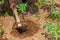 Hands of African rural farmer with farming tool, plowing land.