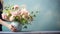 Hands arranging flowers in a vase by bright sunlight