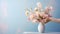 Hands arranging flowers in a vase by bright sunlight