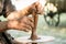 Hands of a artisan creating new clay shape from brown clay