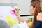 Hands of Asian business people explaining strategies on flip chart in conference room.