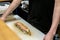 Hands of Asian chefs cooking sushi and Japanese food, making sushi roll