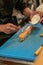 Hands of Asian chefs cooking sushi and Japanese food, making sushi roll