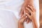 Hands of asian child girl holding elderly grandparent hands wrinkled skin