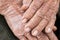 Hands Asian elderly woman grasps her hand on lap, pair of elderly wrinkled hands and Traces of hard work, World Kindness older,