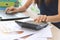 Hands of Asian female accountant working with calculator and computer laptop