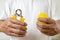 Hands of asian man doing finger,palm and wrist exercise with rubber ball and spring hand gripper,stretch finger,squeeze with hand