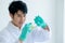 Hands of Asian scientist man use forceps hold pieces of Aloe Vera and prepare to put in glass plate to do some experiment in