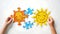 Hands assembling vibrant sun puzzle pieces, concept of fun learning and creativity. Playful educational activity for