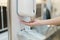 Hands with automatic sanitizer liquid spray machine, touchless dispenser