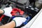 Hands of Automotive Technician using jumper cables to charging vehicle battery