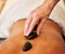 Hands, back and rock massage at spa for stress relief, relaxation and spiritual zen treatment at a resort. Hand of