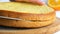 Hands of a baker cook woman with a knife cut an orange biscuit or sponge cake dough in the kitchen. Making Sweet