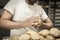 Hands of baker decorating bread