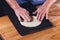 Hands of the Baker knead layer of dough, isolated on black background.