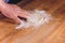 Hands of the Baker knead layer of dough, isolated on black background.