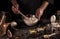 Hands Baker kneaded dough in glass bowl, isolated on black