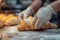 Hands of baker making croissant on table in baker.