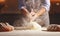 Hands of baker`s male knead dough