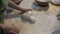 The hands of the bakers kneading forms of dough for bread baking on table