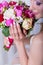 Hands beautiful delicate bride smiling girl with a large bouquet of bright color