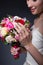 Hands beautiful delicate bride smiling girl with a large bouquet of bright color
