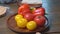 hands beautifully spread tomatoes and sweet pepper on wooden round cutting board