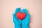 Hands in blue medical gloves holding heart shape. Thank you concept to doctors and medical workers during COVID-19 coronavirus