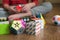 Hands of boy trying to solve the puzzle against various pyramid and cube toy puzzles background. Solving difficult tasks or stay