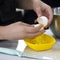 Hands break a raw egg. Separation of egg white from yolk