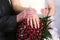 The hands of the bride and bridesmaid wedding bouquet