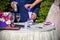 Hands of bride and groom doing sand ceremony during wedding