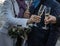 Hands of bride and groom with glasses of champagne and bouquet of bride