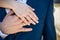 Hands of the bride and groom with gold rings, close-up. Embrace of newlyweds. Creating a loyal family