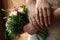 Hands of the bride and groom with wedding rings, bride holds a wedding bouquet in hands, the groom hugs her from behind