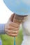 Hands of bride and groom with wedding rings with light blue balloon