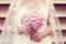 Hands of a bride holding peonies bouquet