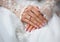 Hands of a bride with a ring and a wedding manicure