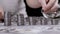 Hands Building a Coin Tower or Stack against the Background of Scattered Money